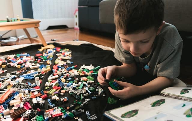 kid playing with legos