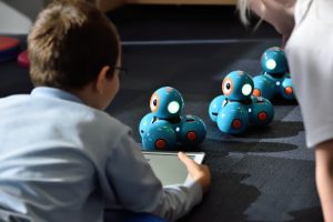 kid playing with robot